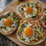 Breakfast flatbreads featuring eggs, cheese, and assorted vegetables